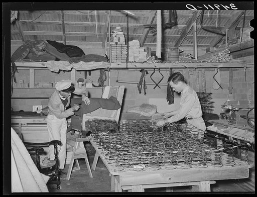 Tying springs and upholstering chair at mattress factory. San Angelo, Texas