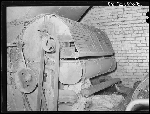 Machine for cleaning cotton linters which are used to stuff mattresses. Mattress factory. San Angelo, Texas