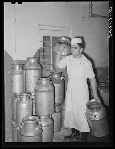Employer at creamery carrying milk cans. Creamery, San Angelo, Texas