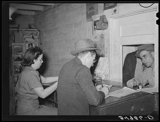 San Angelo, Texas. Buyer paying his bill at office of livestock auction