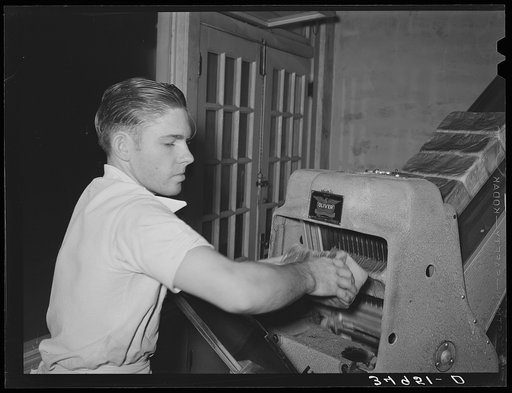 Untitled photo, possibly related to: Slicing bread at bakery. San Angelo, Texas
