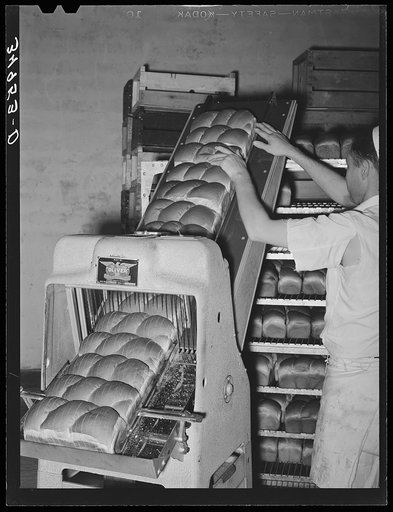 Untitled photo, possibly related to: Slicing bread at bakery. San Angelo, Texas