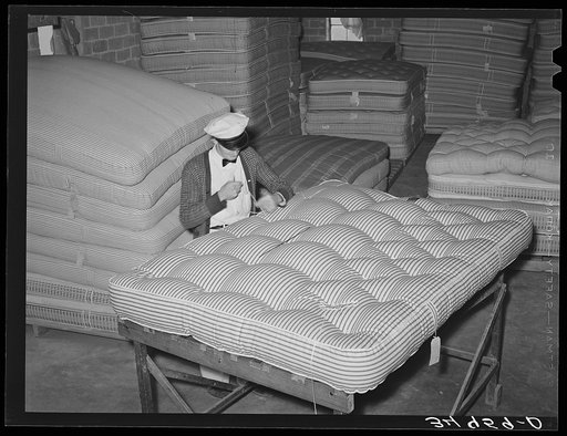 Tufting a mattress. Mattress factory, San Angelo, Texas