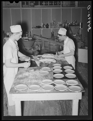 Making and putting pie crusts into pie pans. Bakery, San Angelo, Texas