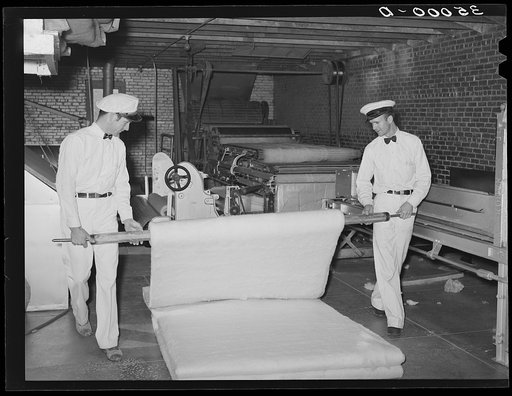 Unrolling cotton batting. Mattress factory, San Angelo, Texas