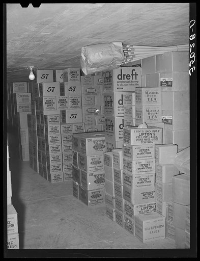 Cartons of groceries in storage at wholesale grocery. San Angelo, Texas