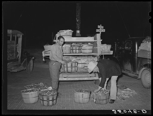 Trucker and small grocer at early morning market. San Angelo, Texas
