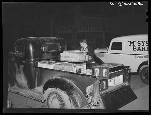 Loading bread onto truck, early morning, at the bakery. San Angelo, Texas