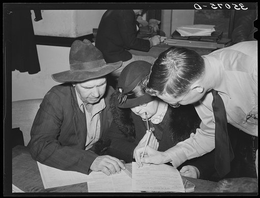Supervisor helping FSA (Farm Security Administration) clients make out farm and home plans. Mason, Texas