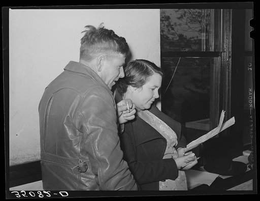 FSA (Farm Security Administration) client and his wife studying farm and home plan at meeting. Mason, Texas