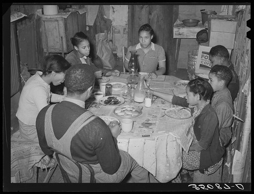 Family of Pomp Hall, Negro tenant farmer, eating breakfast consisting of corn flakes, biscuits, fried bacon, milk and coffee. Creek County, Oklahoma. See general caption number 23
