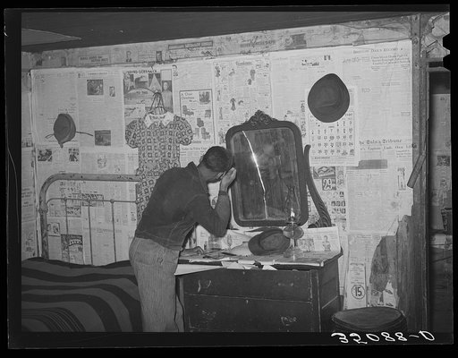 Oldest son of Pomp Hall, Negro tenant farmer, combing his hair. Creek County, Oklahoma. See general caption number 23