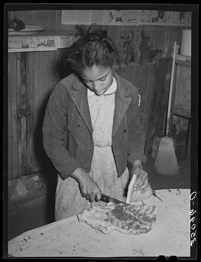 Daughter of Pomp Hall, Negro tenant farmer, slicing bacon. Creek County, Oklahoma. See general caption number 23