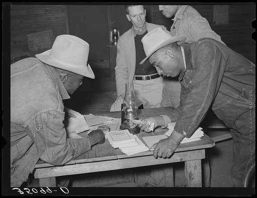 Officials of local chapter of UCAPAWA (United Cannery, Agricultural, Packing, and Allied Workers of America) agricultural union, looking over newspaper clippings. Creek County, Oklahoma