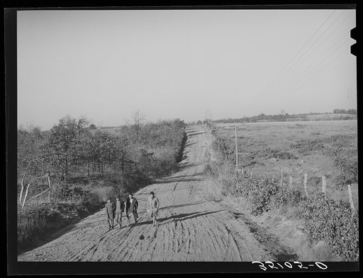 Children of Pomp Hall, Negro tenant farmer, climbing hill on country road on their way to school. Creek County, Oklahoma. See general caption number 23