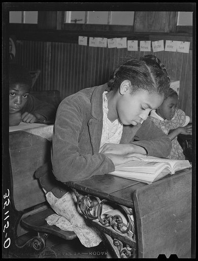 Daughter of Pomp Hall, Negro tenant farmer, studying at her desk in rural school. Creek County, Oklahoma. See general caption number 23