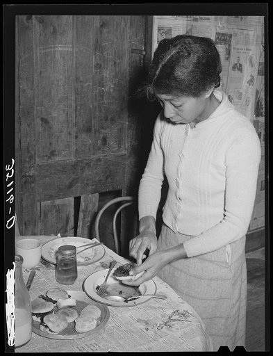 Wife of Pomp Hall preparing school lunches for her children. Creek County, Oklahoma. See general caption number 23