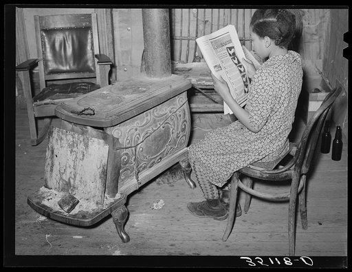 Daughter of Pomp Hall, tenant farmer, reading about chickens in farm magazine. She raises chickens as her 4-H Club project. Creek County, Oklahoma. See general caption number 23