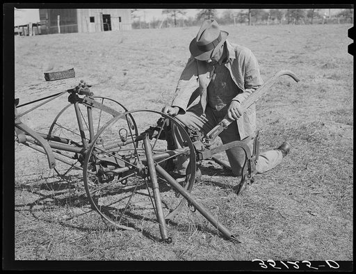 Pomp Hall, Negro tenant farmer, adjusting his cultivator so it will be in readiness for the spring planting. Creek County, Oklahoma. See general caption number 23