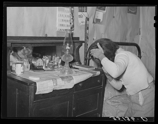 Wife of Pomp Hall, Negro tenant farmer, combing her hair in the morning. Creek County, Oklahoma. See general caption number 23
