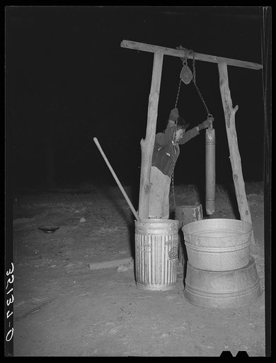 Drawing water from the well in the early morning. Farm of Pomp Hall, Negro tenant farmer. Creek County, Oklahoma. See general caption number 23