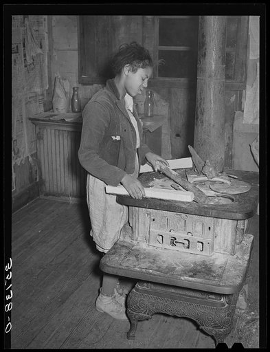 Daughter of Pomp Hall, Negro tenant farmer, building fire in the morning. Smoke is in her eyes. Creek County, Oklahoma. See general caption number 23