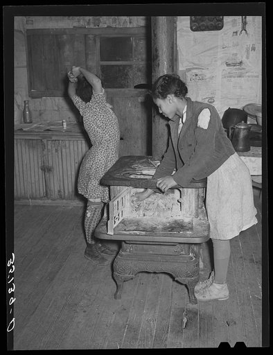 Untitled photo, possibly related to: Daughter of Pomp Hall, Negro tenant farmer, building fire in the morning. Smoke is in her eyes. Creek County, Oklahoma. See general caption number 23