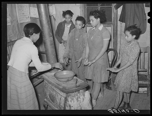 Children of Pomp Hall, Negro tenant farmer, standing around stove. Creek County, Oklahoma