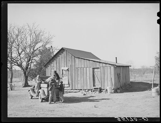 Pomp Hall, his wife and children unloading truck after a trip to town. Creek County, Oklahoma. See general caption number 23