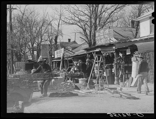 Secondhand row, Oklahoma City, Oklahoma. Oklahoma City seems to have an unusually large number of these cheap secondhand stores, probably because of the floating oil workers and currently shifting populations in surrounding rural areas