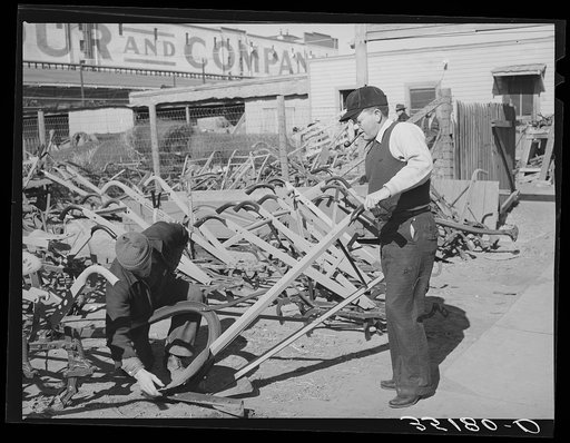 Salesman showing walking plow to prospective buyer. Oklahoma City, Oklahoma