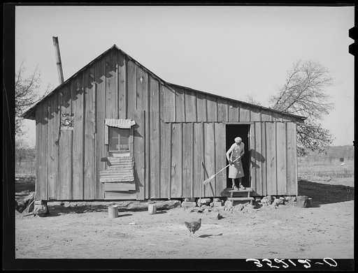 Wife of Pomp Hall, Negro tenant farmer, sweeping off the kitchen steps. Creek County, Oklahoma. See general caption number 23