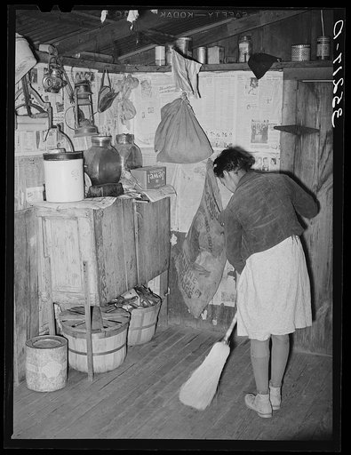 Daughter of Pomp Hall, Negro tenant farmer, sweeping the kitchen floor. Creek County, Oklahoma. See general caption number 23