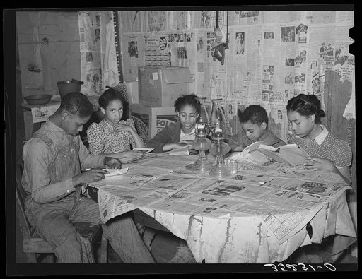 Five children of Pomp Hall, Negro tenant farmer, studying their lessons by lamplight. Creek County, Oklahoma. See general caption number 23