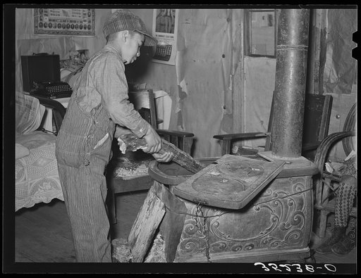 Son of Pomp Hall, Negro tenant farmer, building the fire. Creek County, Oklahoma. See general caption number 23