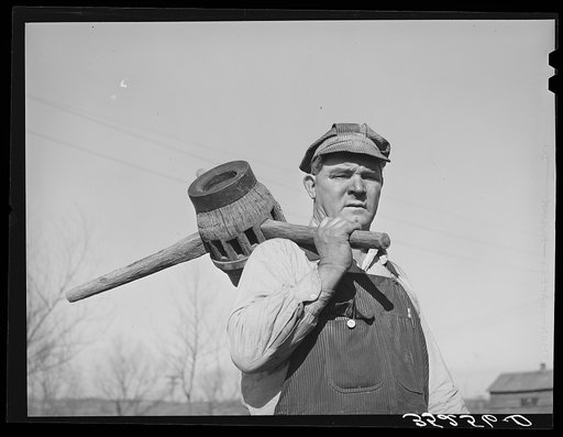 Blacksmith with wagon wheel hub and spokes. Depew, Oklahoma