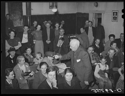 Untitled photo, possibly related to: Auctioning off the pies at pie supper in the school house. Muskogee County, Oklahoma. See general caption number 24