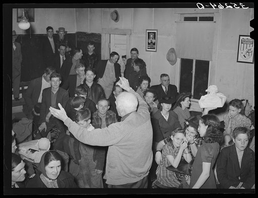 Auctioning off the pies at pie supper in the school house. Muskogee County, Oklahoma. See general caption number 24
