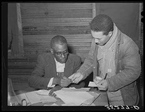 Paying dues at agricultural workers union at Tabor, Oklahoma