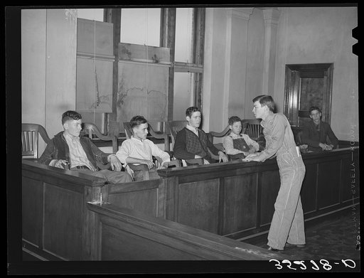 At county 4-H Club meeting members from one community put on a one act play in which Farmer Brown was tried and indicted for "cruelty to his farm." His neighbors testified to his spurning of soil conservation practices, etc. District attorney is shown charging the jury. Eufaula, Oklahoma
