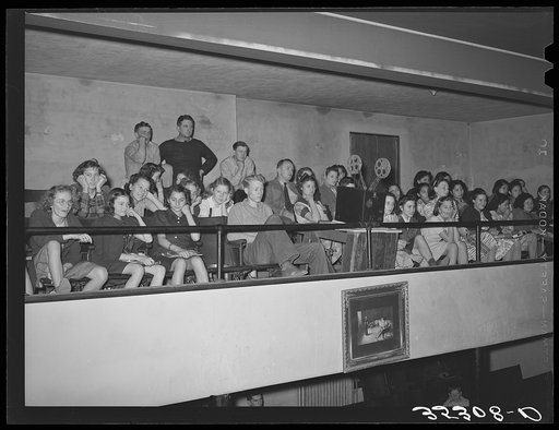 High school students in balcony of school auditorium watching moving picture which was part of the Americanization program. Eufaula, Oklahoma