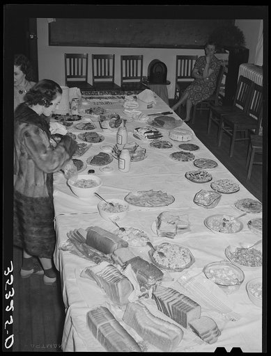 Wife of Jaycee member bringing food to the buffet supper at the high school. Eufaula, Oklahoma. See general caption number 25