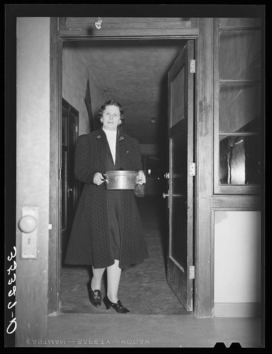 Wife of Jaycee member bringing food to the buffet supper at the high school. Eufaula, Oklahoma. See general caption 25