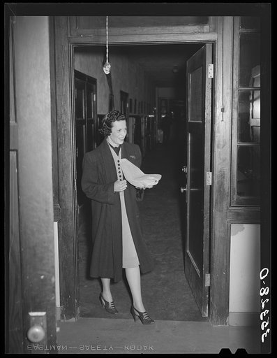 Wife of Jaycee member bringing food to the buffet supper at the high school. Eufaula, Oklahoma. See general caption 25