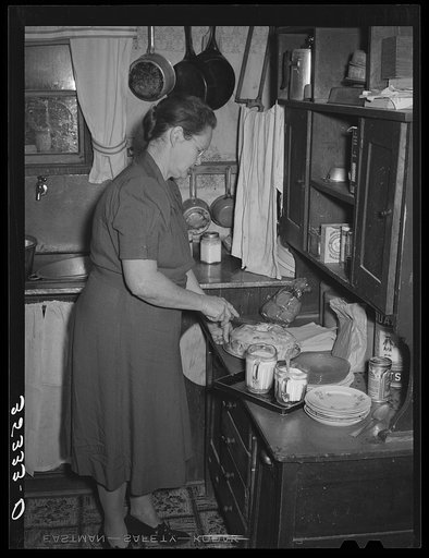 Hostess of home demonstration club marking cake for cutting. Eufaula, Oklahoma