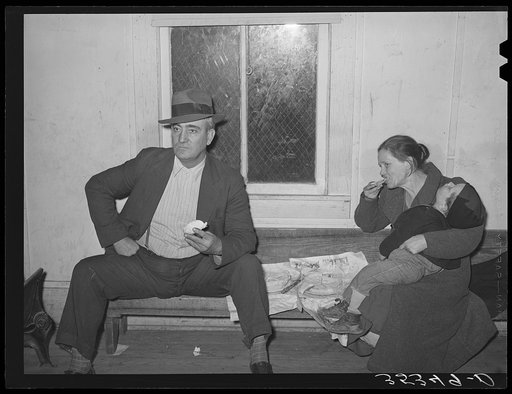 Farmer with his wife and child eating pie at pie supper. McIntosh County, Oklahoma. See general caption number 24