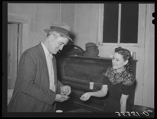 Paying for pie which he bought at auction at pie supper in Muskogee County, Oklahoma. See general caption number 24