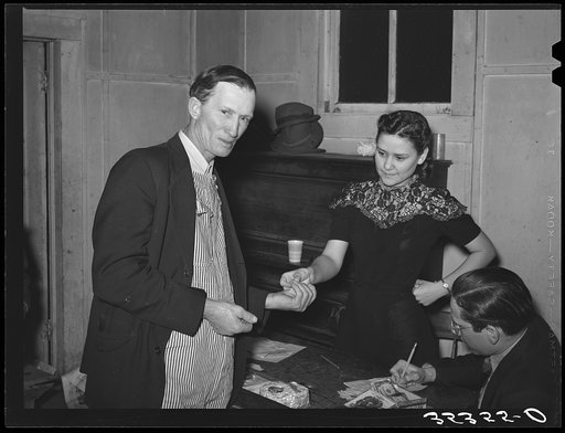 Untitled photo, possibly related to: Paying for pie which he bought at auction at pie supper in Muskogee County, Oklahoma. See general caption number 24
