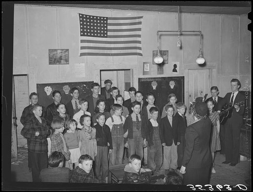 Schoolchildren, directed by their music teacher, sing at the pie supper. McIntosh County, Oklahoma. See general caption number 24