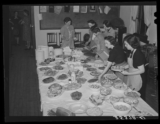 Arranging food on table at buffet supper of the Jaycees at Eufaula, Oklahoma. See general caption number 25